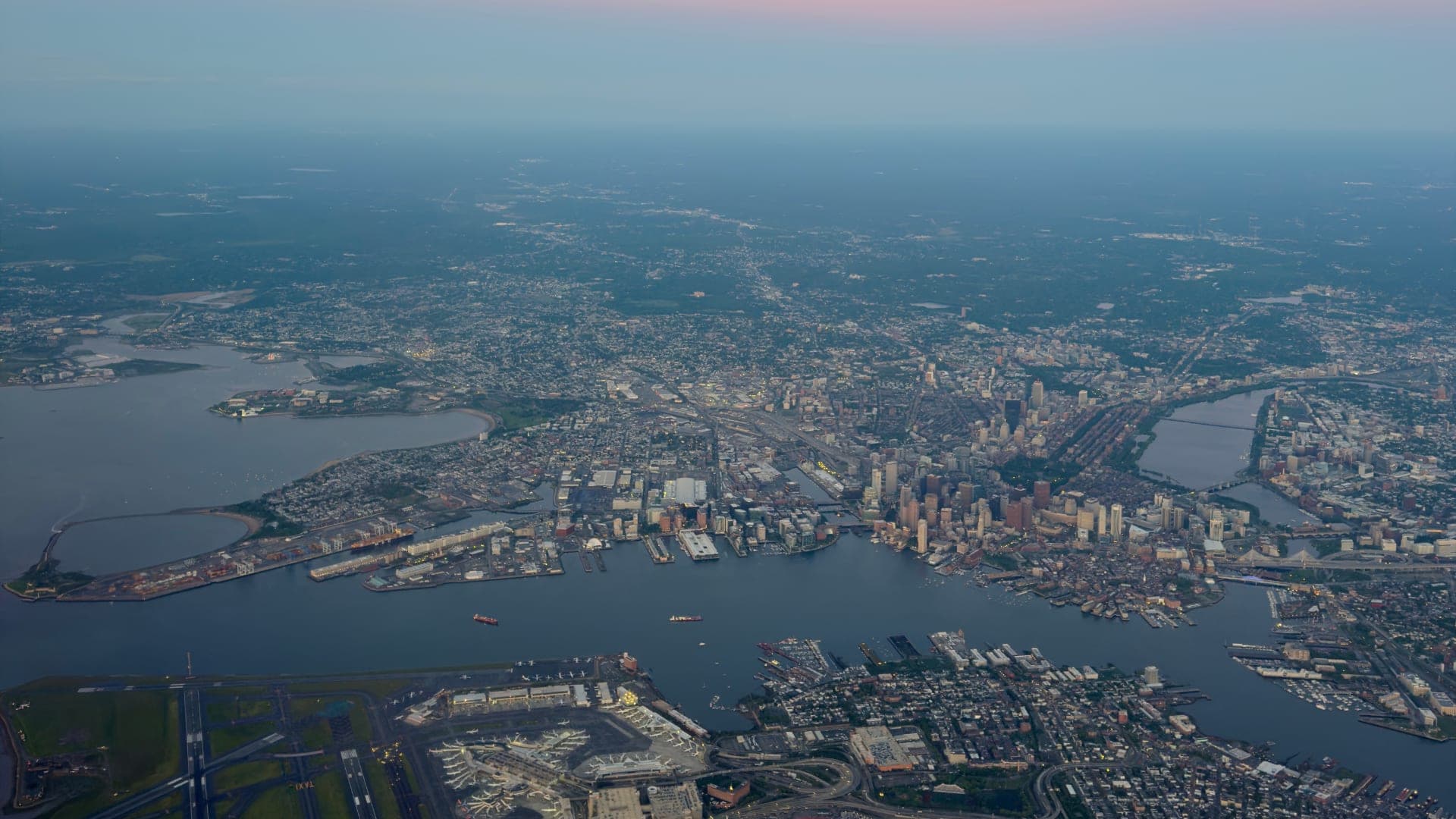 Aerial view of Boston and its harbor at dusk